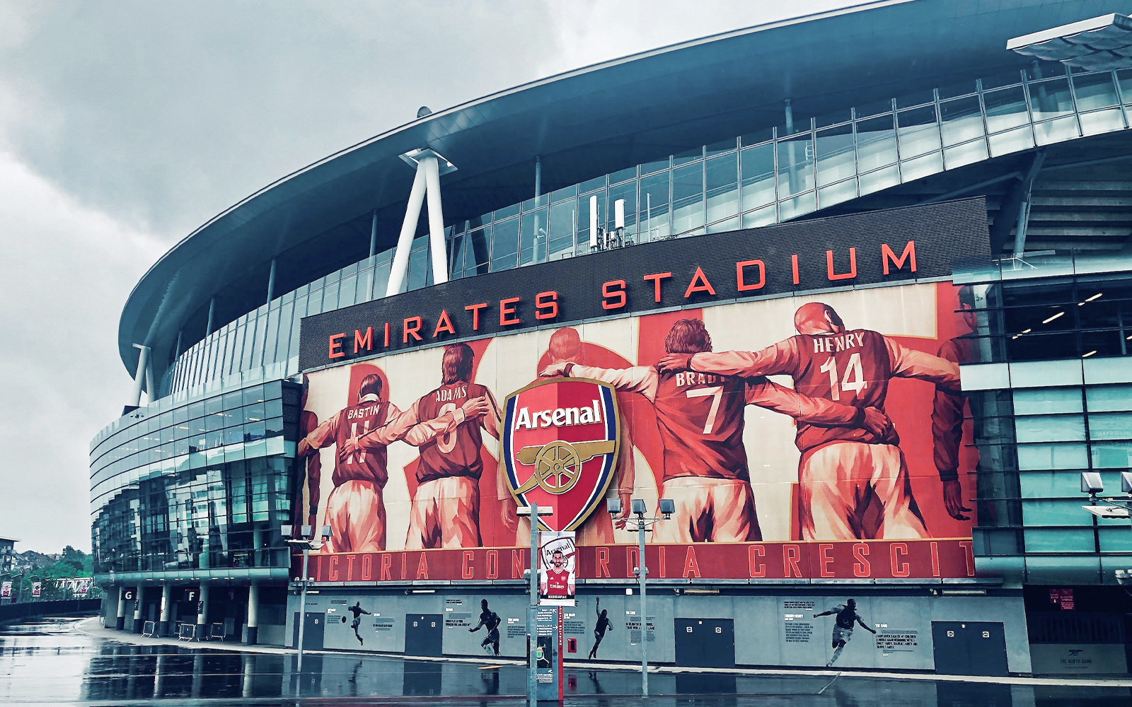 Arsenal FC Emirates Stadium exterior with tour visitors exploring the iconic venue in London.